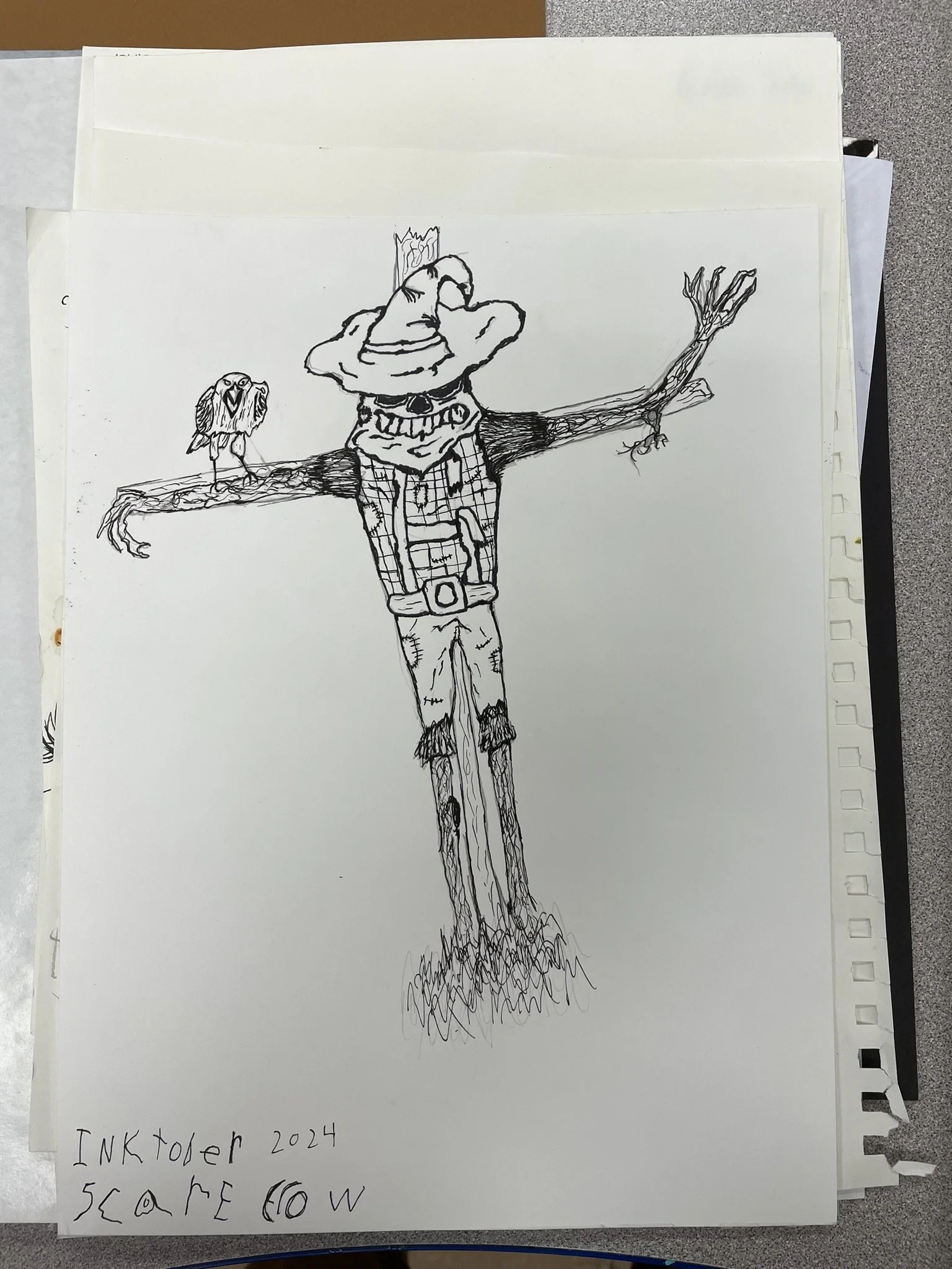 Black and white ink drawing of a scarecrow with a bird perched on its arm, wearing a witch hat and checkered shirt, with handwritten text at the bottom that says 'Inktober 2024 scare crow'.