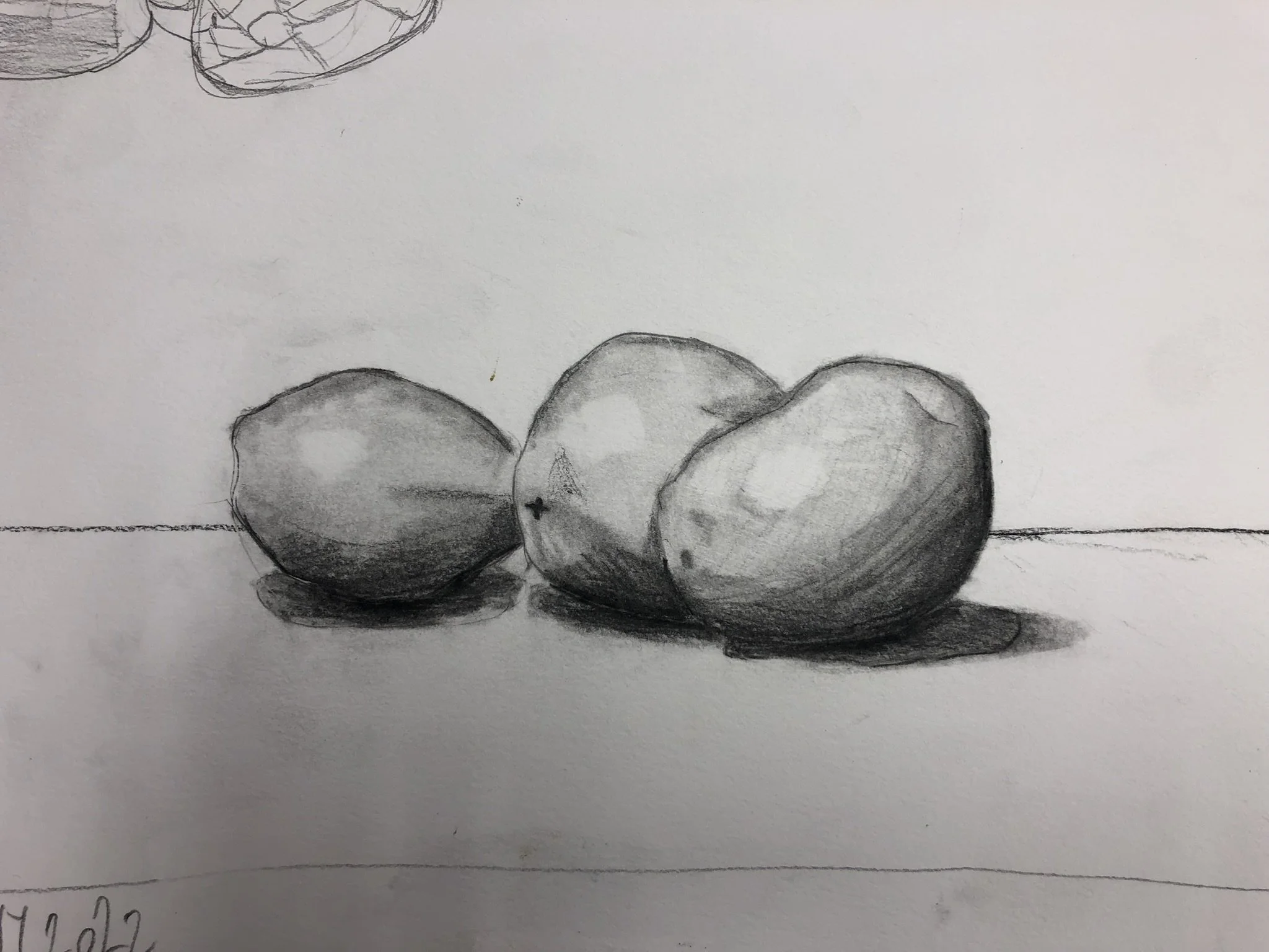 Black and white pencil sketch of three apples placed on a table with shadows underneath, with a faint line in the background.