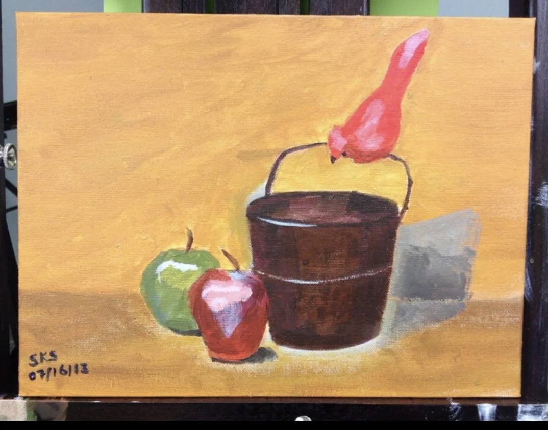 Painting of a green apple, a red apple, a brown bucket, and a pink bird on top of the bucket against a yellow background.