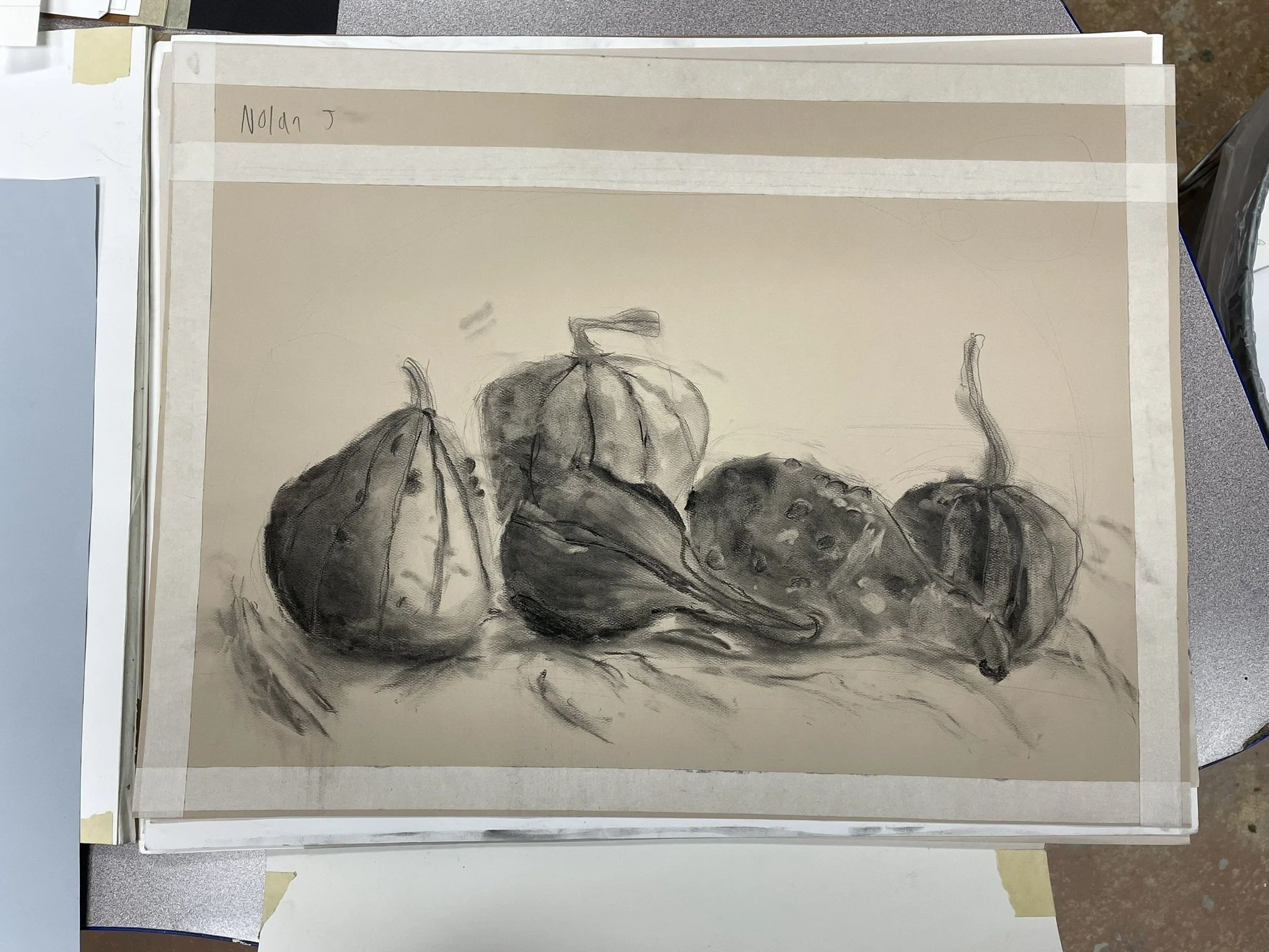 A black and white still life drawing of four gourds and vegetables on a flat surface.
