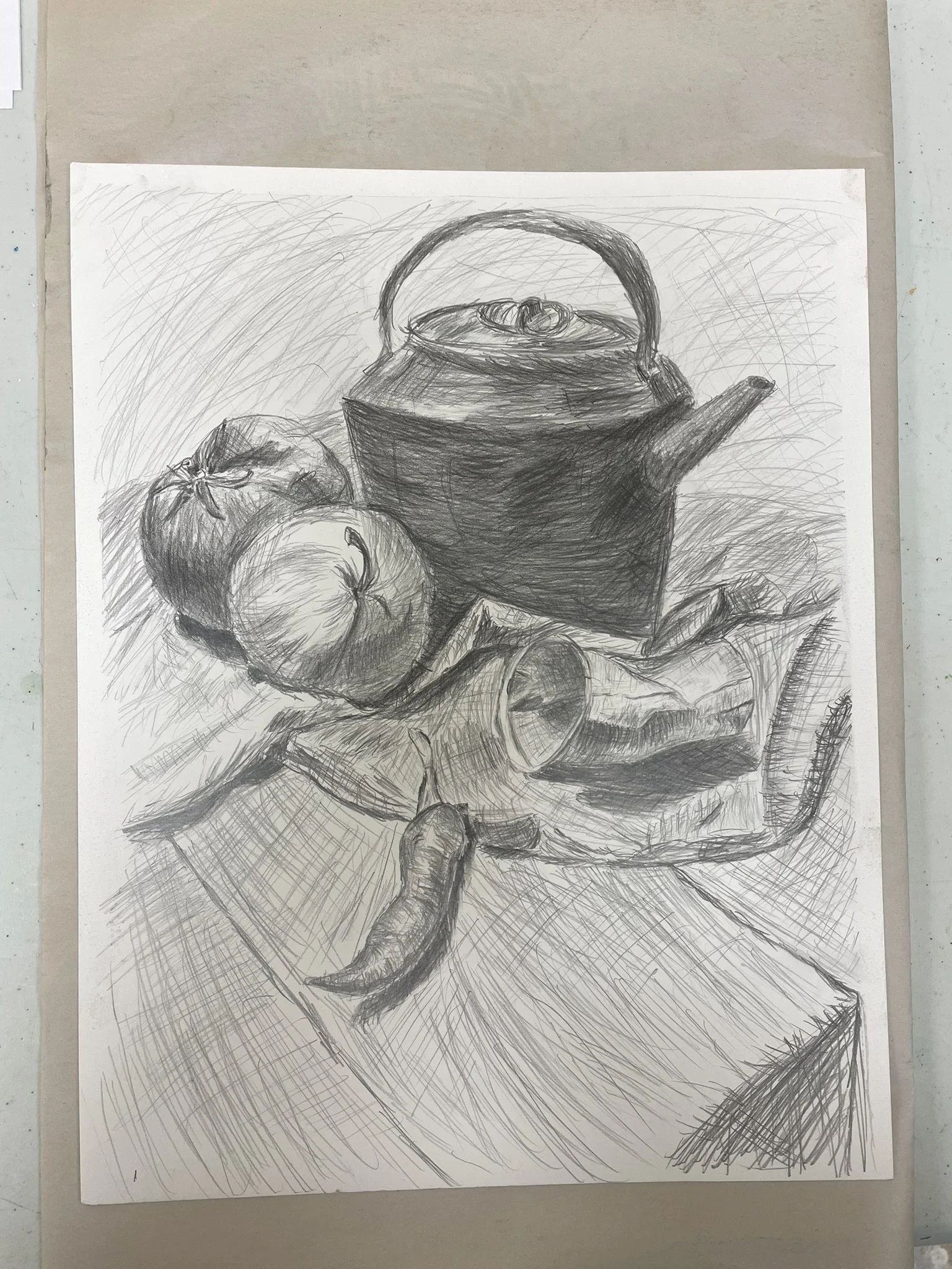 A pencil sketch of a still life featuring a teapot, two tomatoes, a fish with an open mouth, and a chili pepper on a wooden surface.