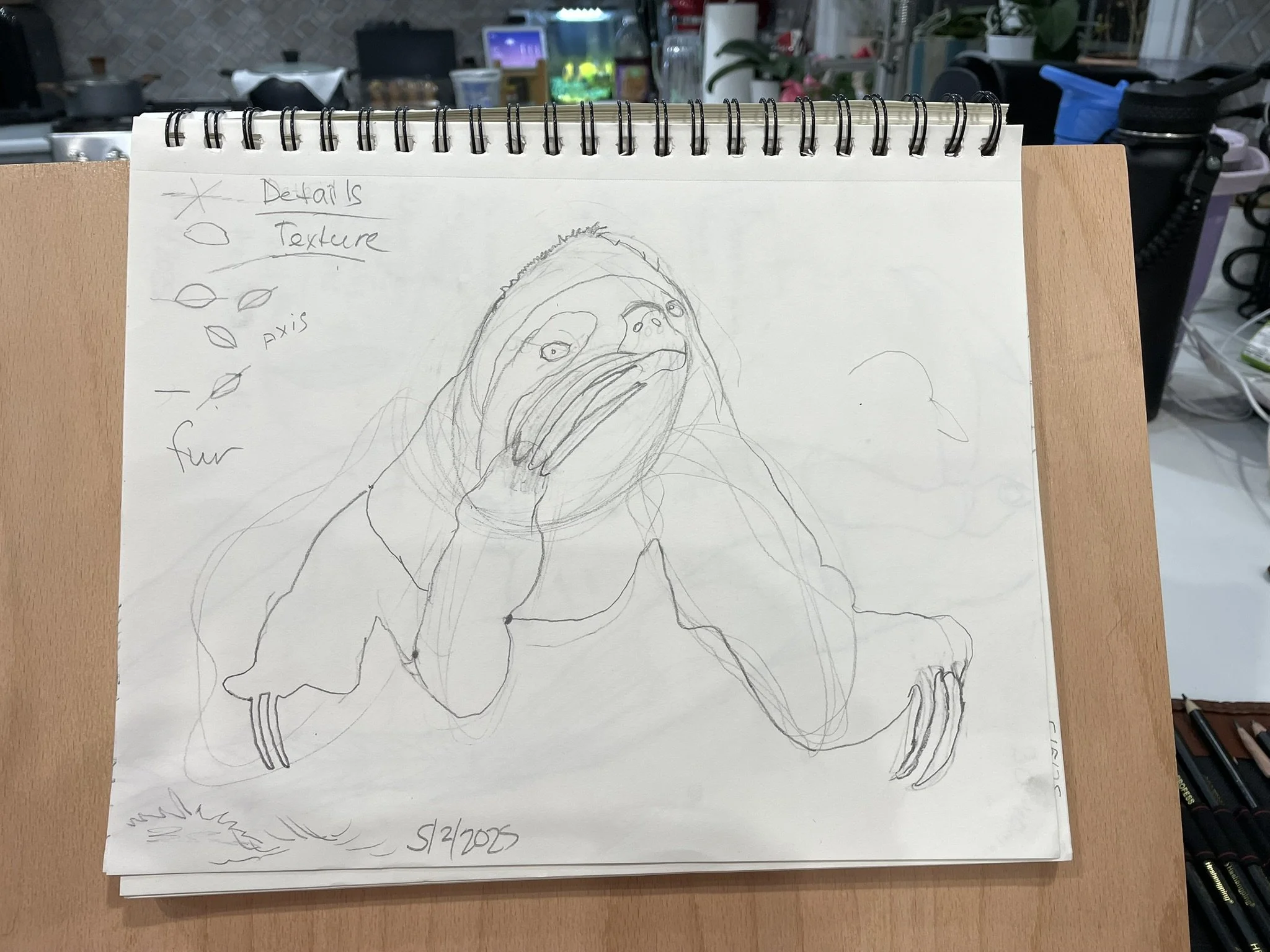 A sketch of a creature with a large face, long nose, and open mouth, resting its hand on its face. The drawing is on a spiral-bound notepad. There are handwritten notes in the upper left corner and a date at the bottom.