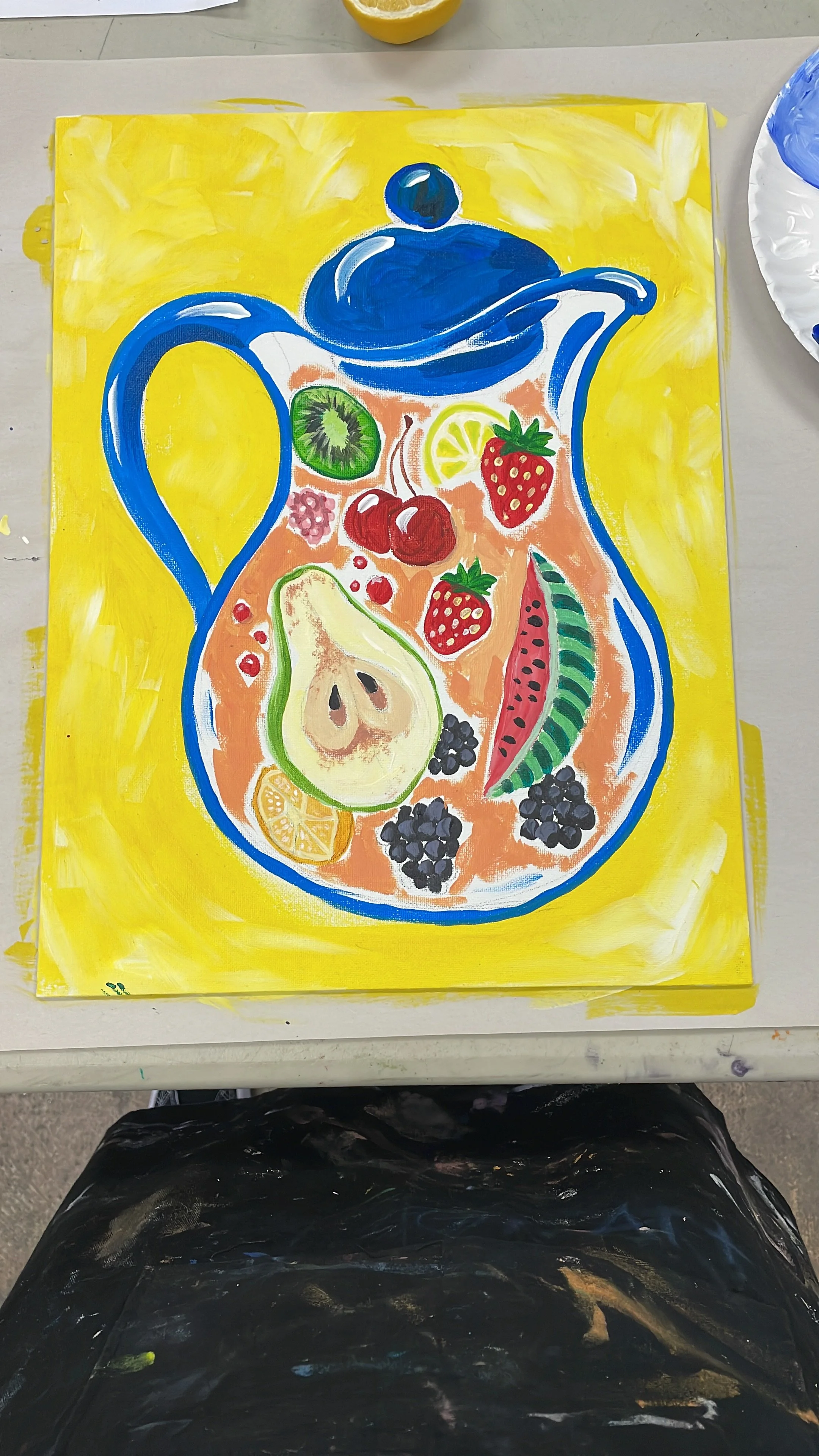 Painting of a blue teapot filled with various fruits including kiwi, lemon, strawberry, cherry, watermelon, pear, blueberry, and lemon slices, on a yellow background.