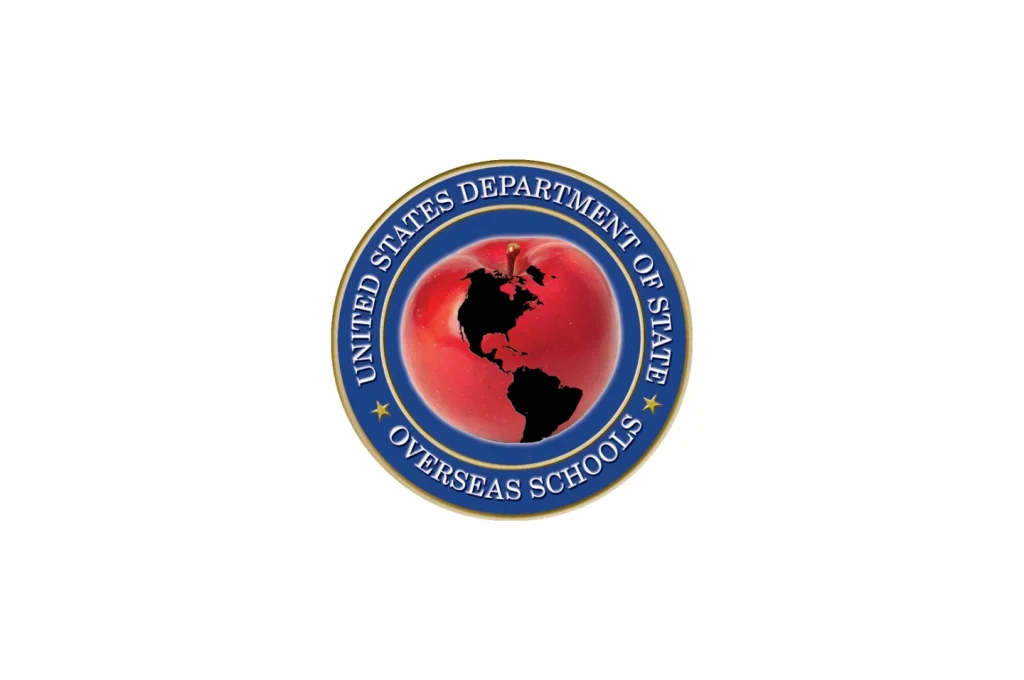 Seal of the United States Department of State with a globe showing North and South America on a red background, encircled by a blue ring with gold stars, and the text 'United States Department of State Overseas Schools'.