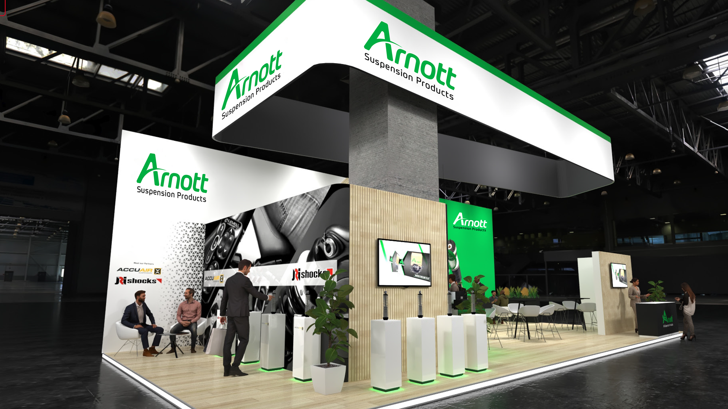 Trade show booth for Arnott Suspension Products, featuring large screens, display items, and seating area, with company logos and branding in green, white, and black.