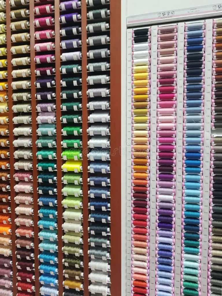 Colorful embroidery thread spools organized in a display rack.
