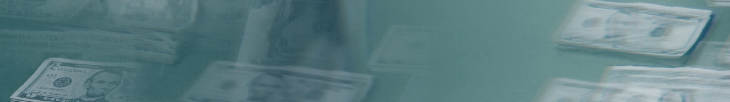 Blurred image of U.S. dollar bills on a reflective surface.