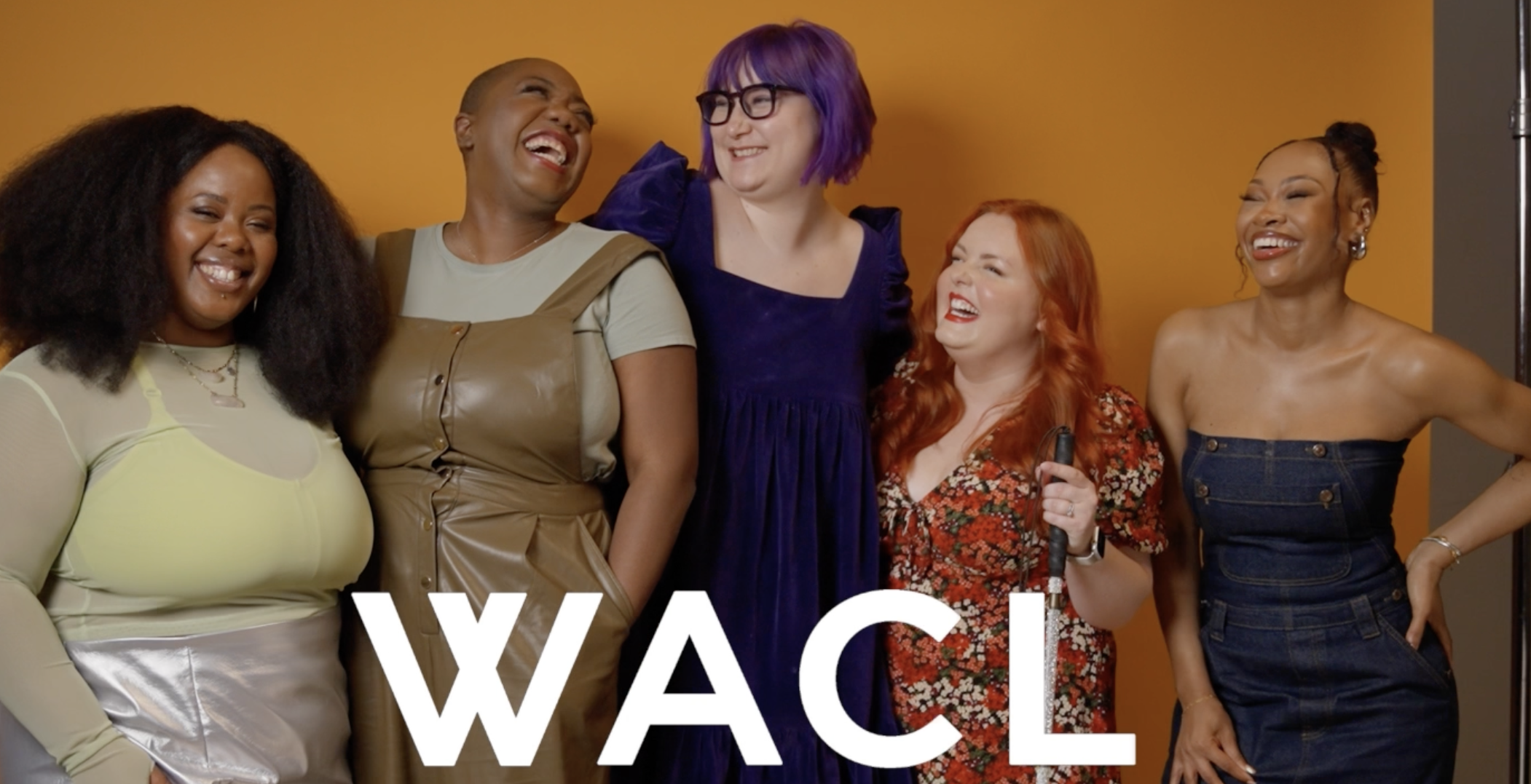 Six women laughing and smiling together against a yellow background, with the word 'WACL' in white letters at the bottom.