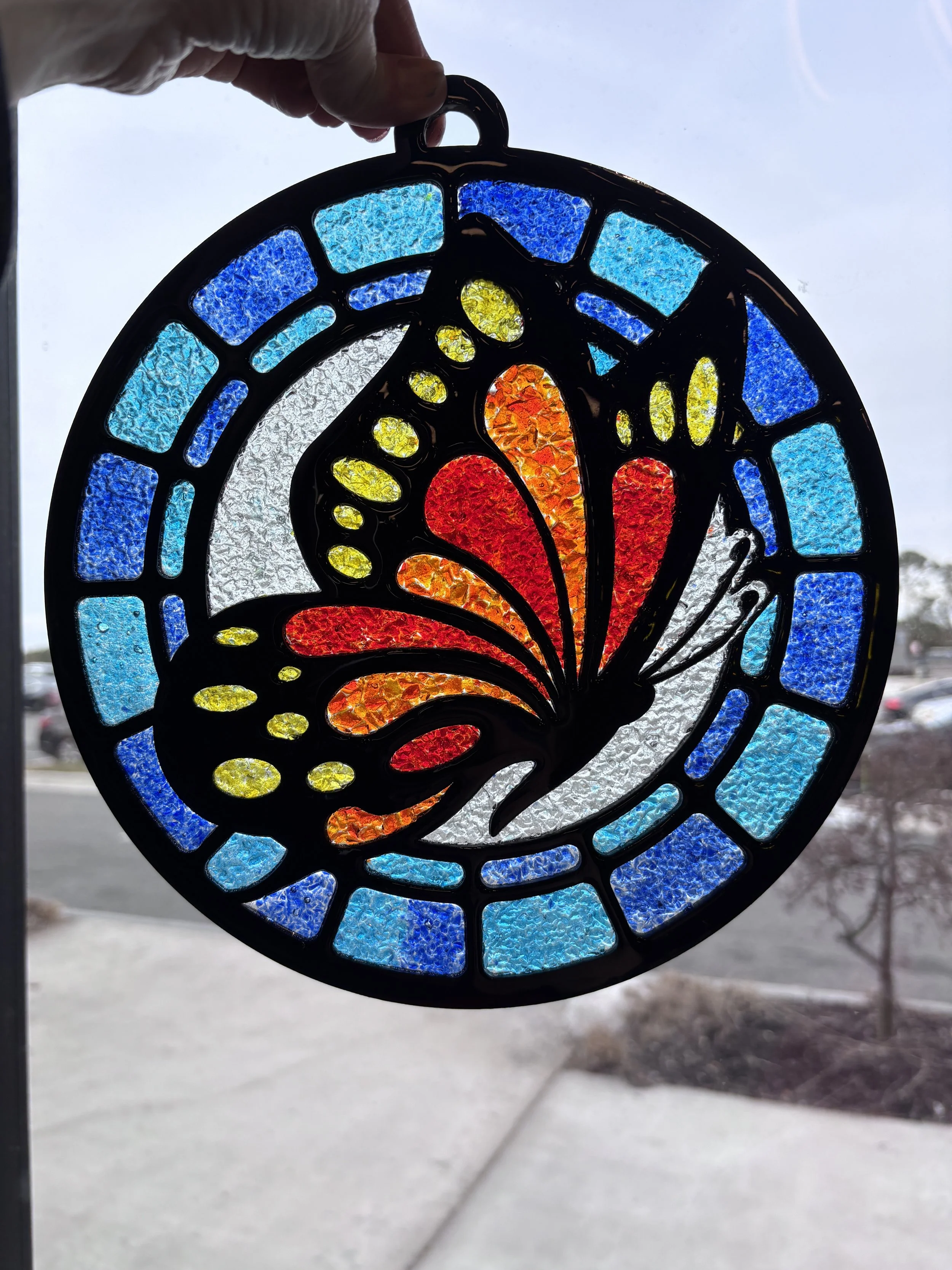 Crushed glass peacock suncatcher, laser-cut wood design, colorful glass, epoxy resin, glossy finish, stained-glass art class. Make resin art suncatchers in Henrico, VA.