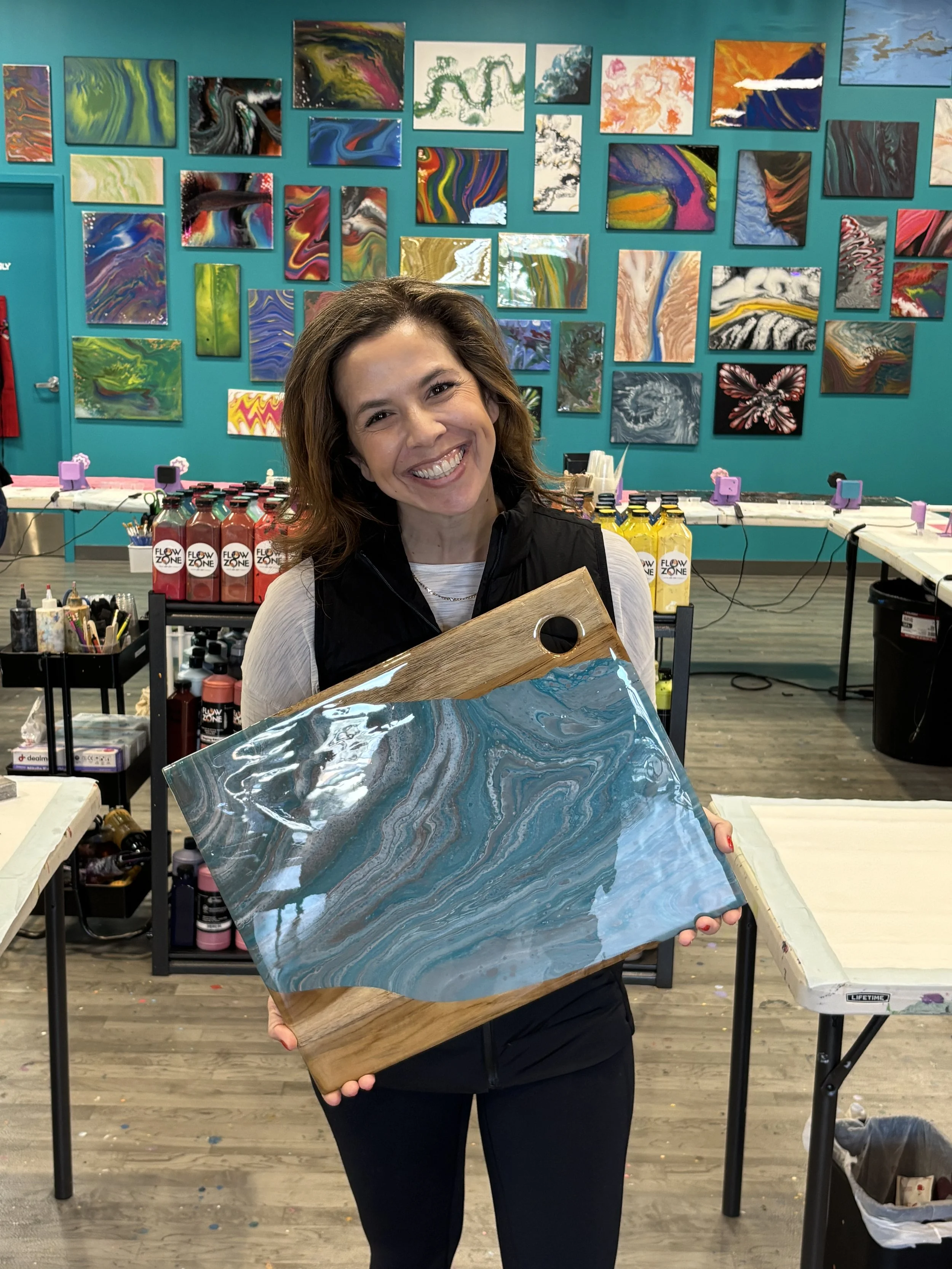stunning display of fluid art charcuterie boards, art studio customers create serving board, pour painting, resin epoxy at an art class in Henrico, VA