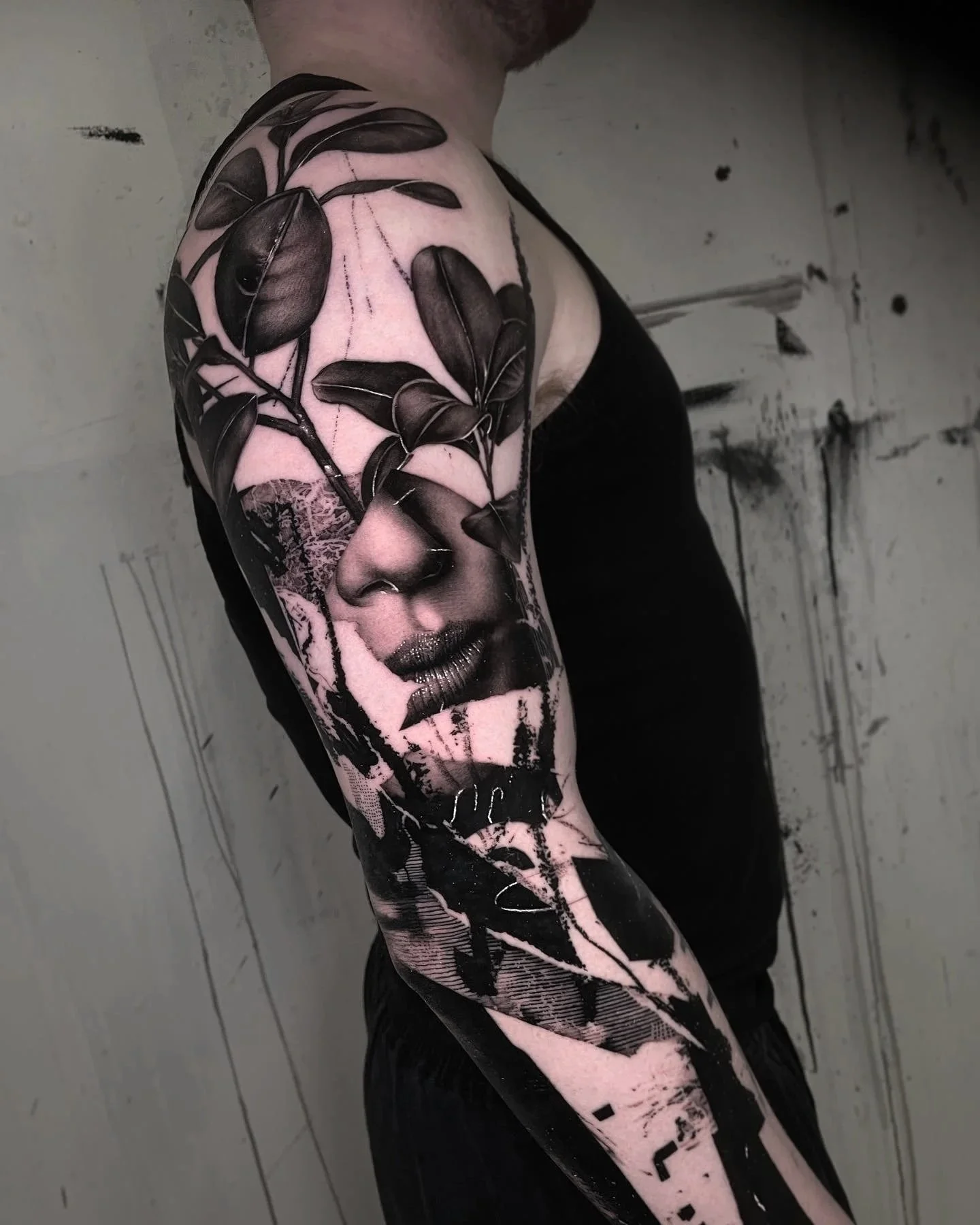 graphic and abstract realistic tattoo sleeve with womans face black and grey