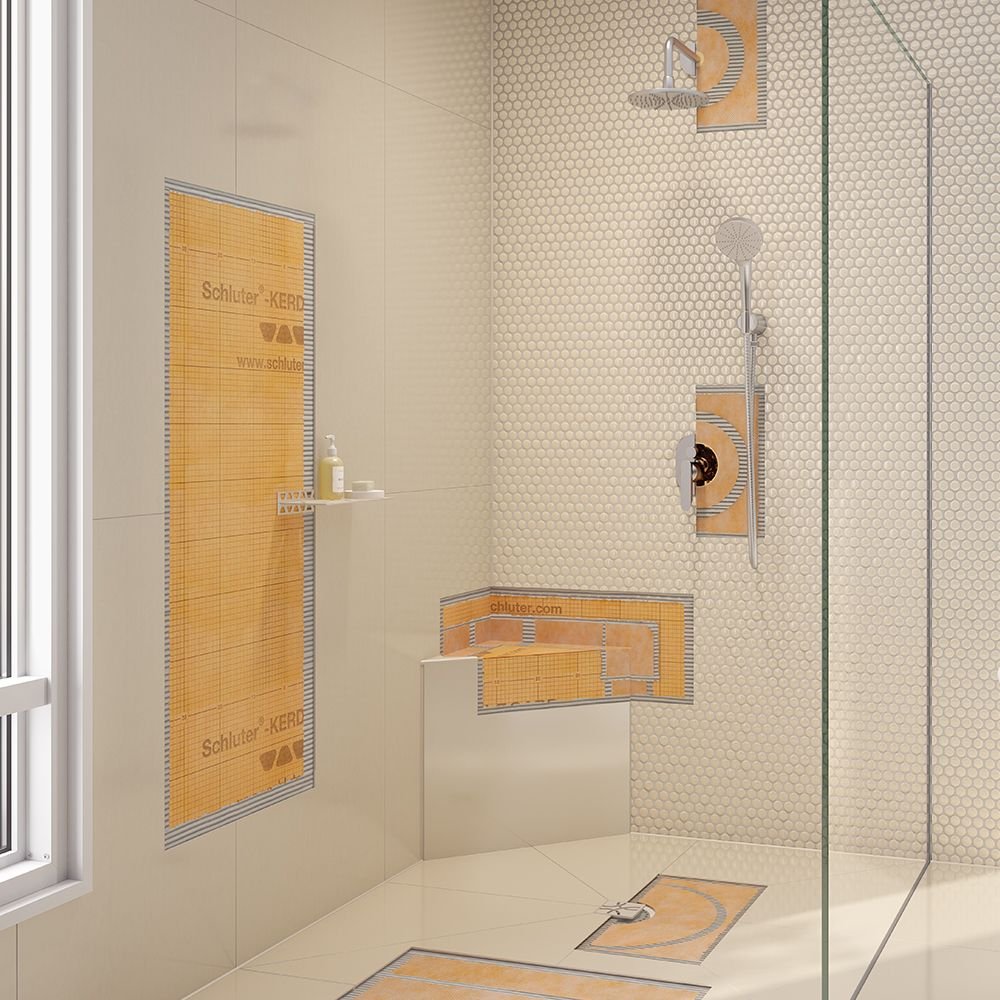 Modern walk-in shower with beige tile walls, a rain showerhead, a handheld shower, and protective orange and transparent adhesive coverings on fixtures and water access points.