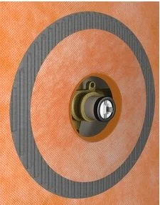 Close-up of a circular window lock with a gray frame, mounted on an orange surface.