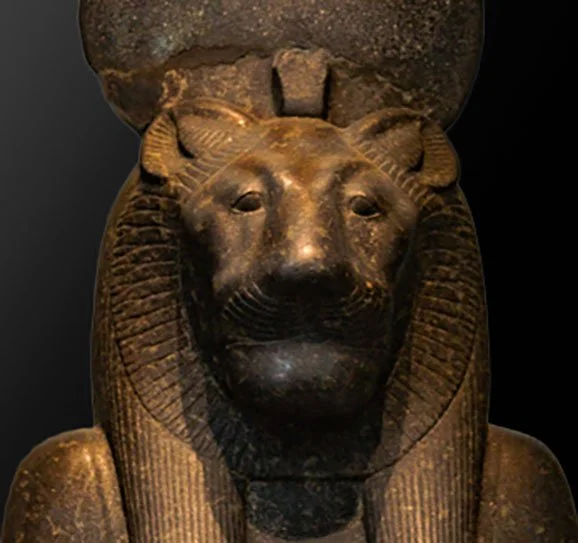 Dark stone statue lioness face of Goddess Sekhmet.