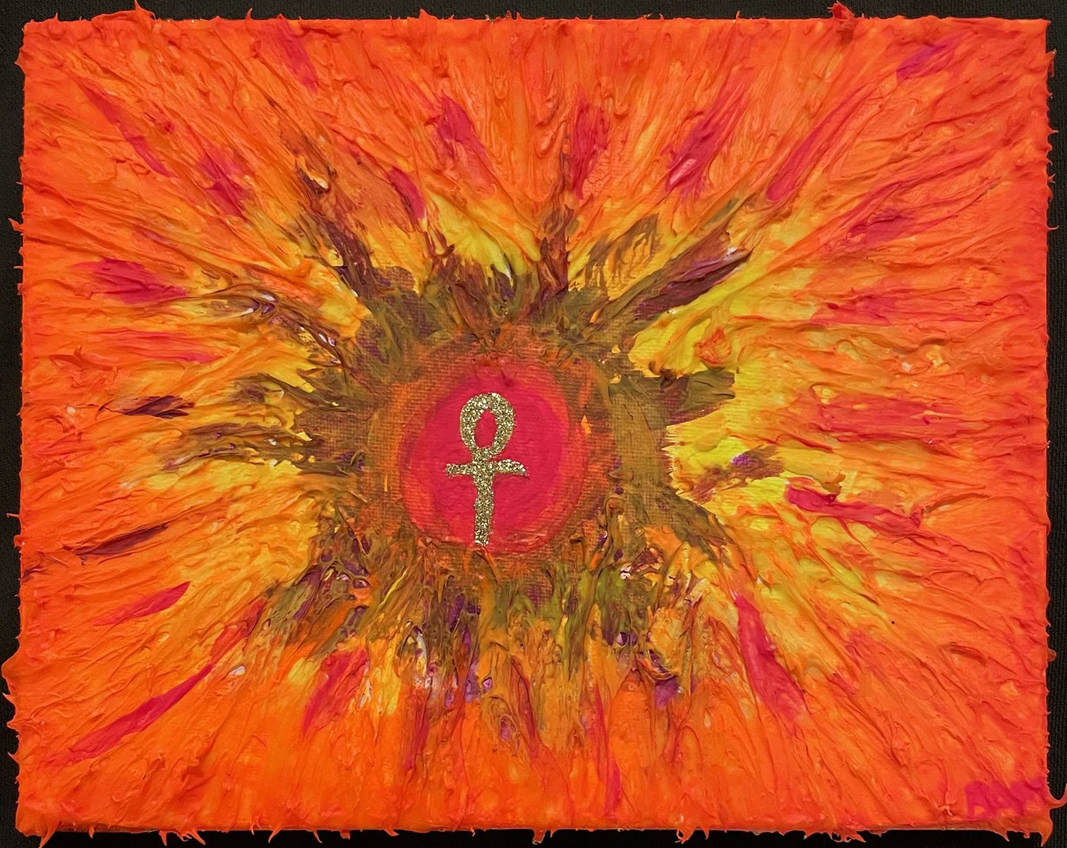 Golden ankh in red circle surrounded by explosion of brown, yellow, red, orange.
