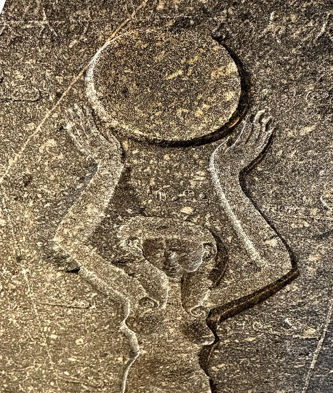 Ancient Egyptian stone relief of a female figure holding the Aten sun disk overhead, illustrating the origins of an ancient Egyptian meaning‑making system created during a period of rapid societal transition.