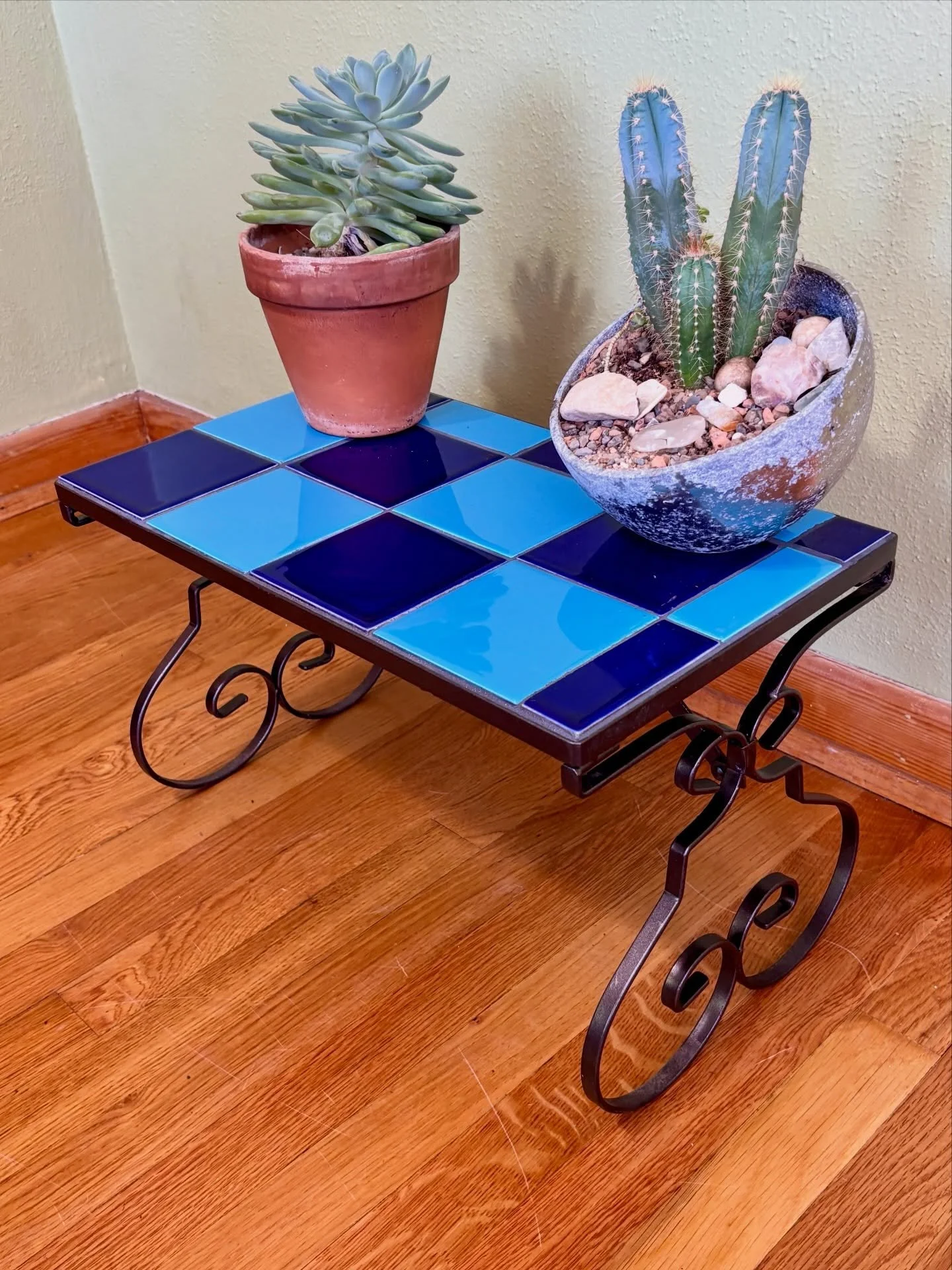 FOR SALE : Hand-tiled stand featuring deep navy + sky blue squares on a metal base. Perfect as a plant stand, low bench, or entryway moment.

Deets:
✨ One of a kind
✨ Durable tile surface
✨ Indoor/outdoor friendly

Dimensions:
19&rdquo; W
11&rdquo; D