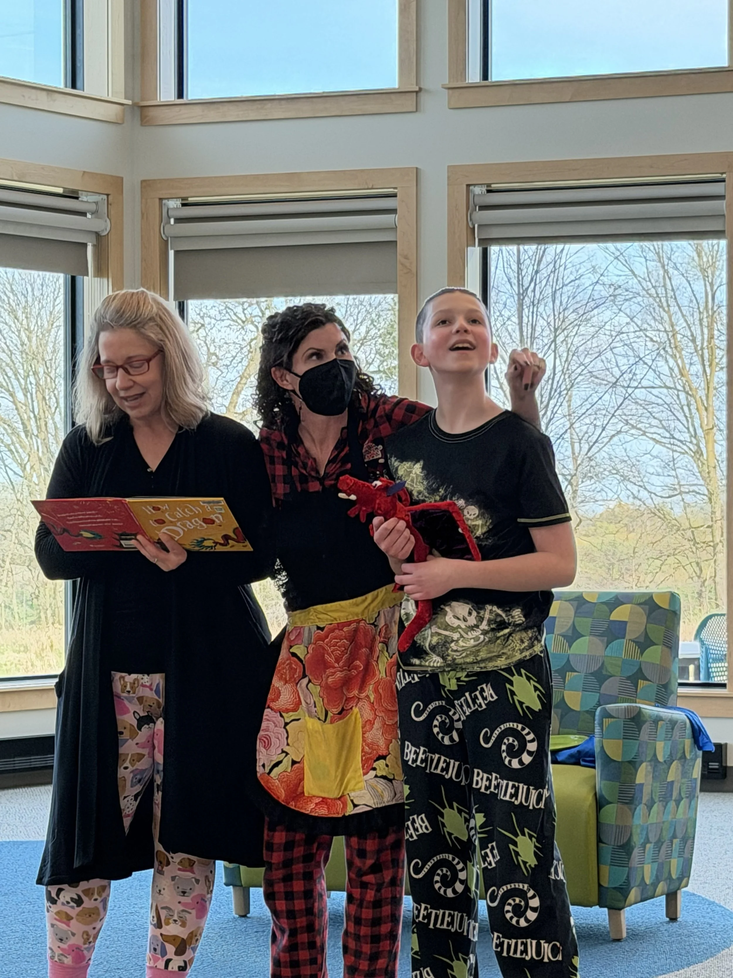 3 people with the book How to Catch a Dragon gathered together