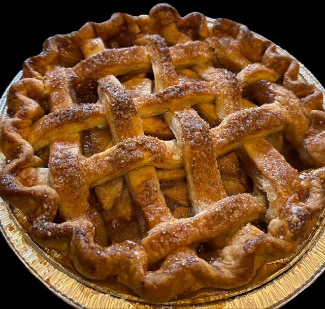 Close-up of a freshly baked apple pie with a lattice crust, dusted with sugar.