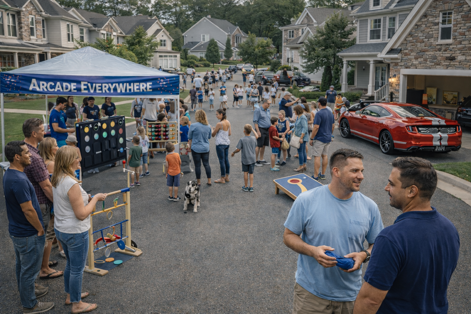 A neighborhood block party with families, children, and adults engaging in games and socializing on a driveway and street, with a blue canopy labeled 'ARCADE EVERYWHERE' and various carnival-style game booths.