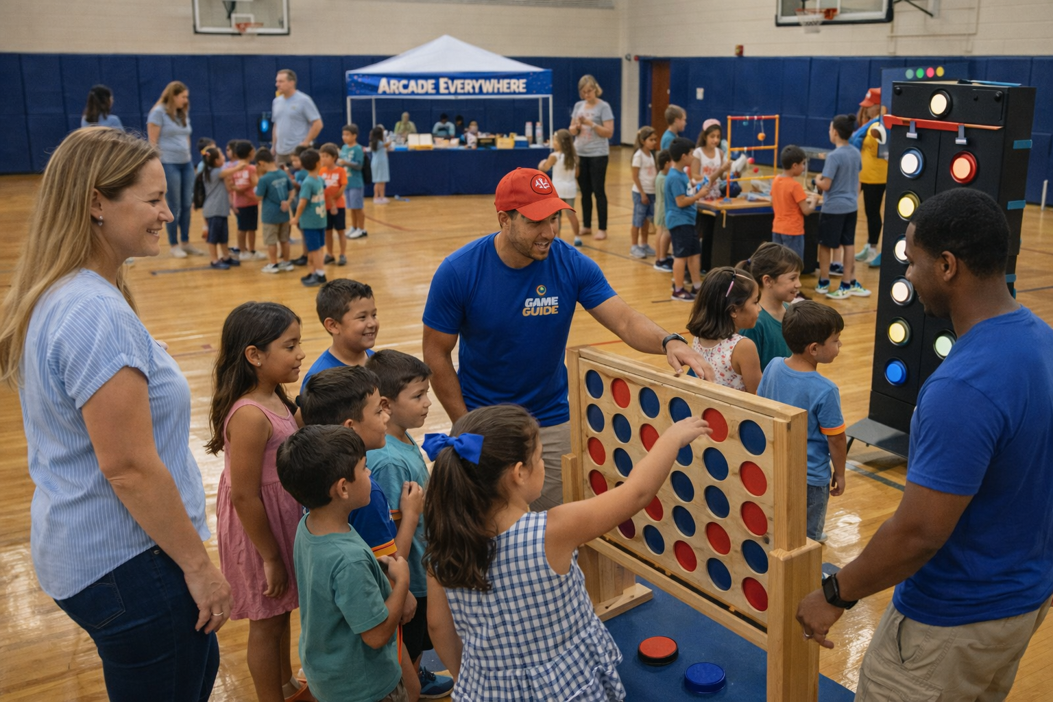 Children and adults playing large connect four game at a carnival or indoor event in a gymnasium.