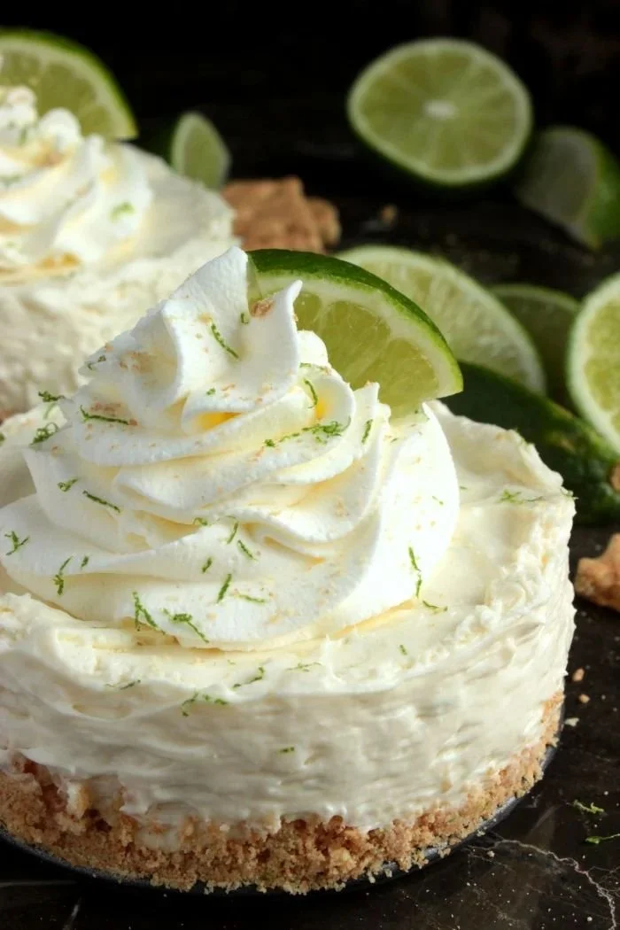 Key lime cheesecake with whipped cream and lime slices