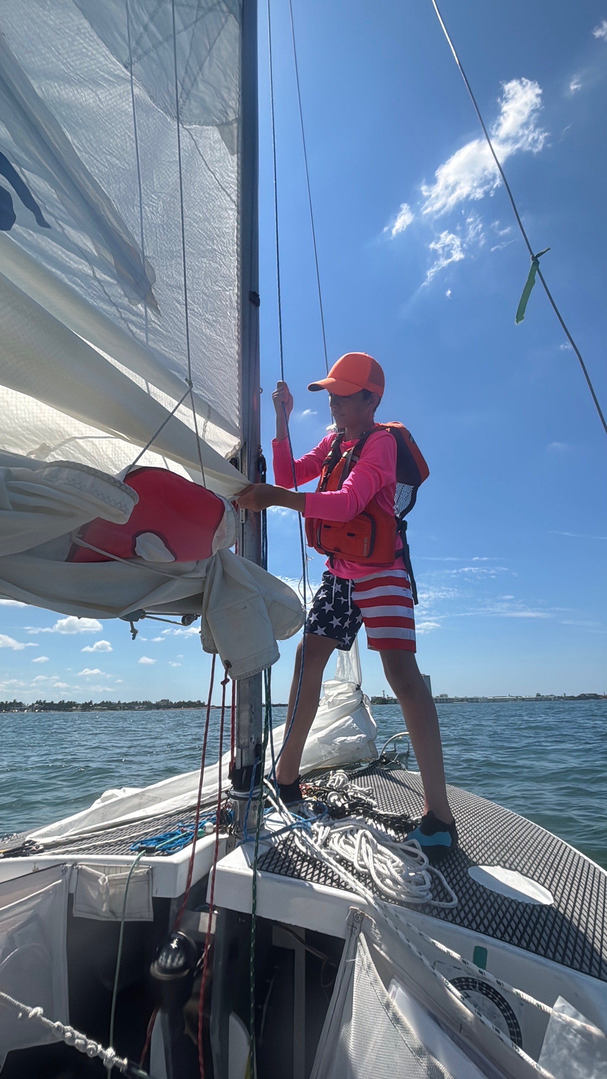 Lowering the mainsail into the lazy jacks "basket."