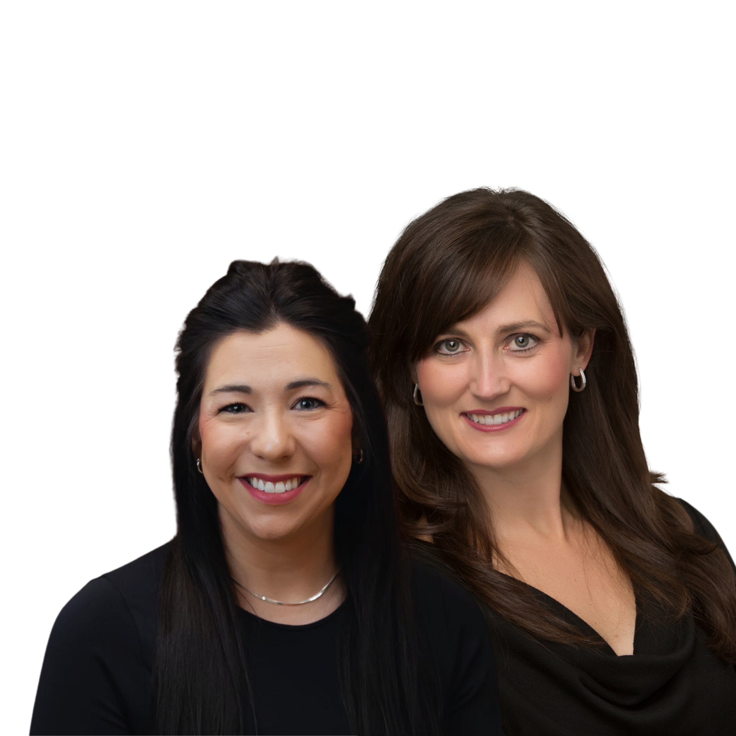 Two women smiling, one with long black hair and the other with long brown hair, wearing black tops and silver jewelry