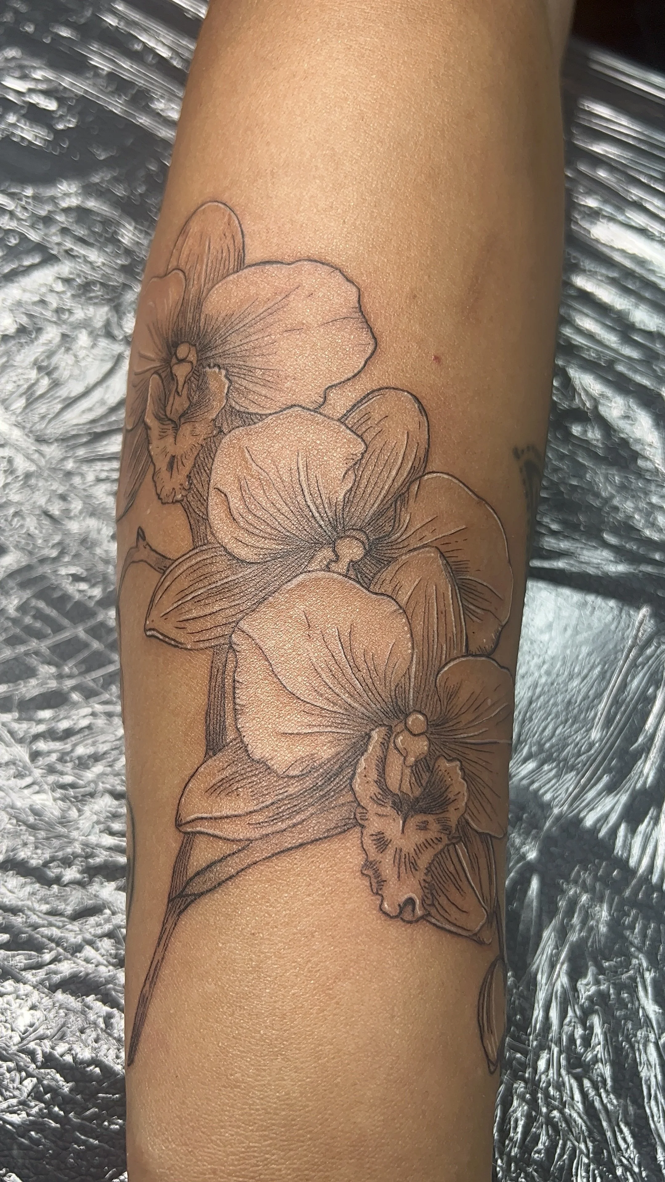 Fine Line Botanical Floral Tattoo featuring line work and black and grey technique.