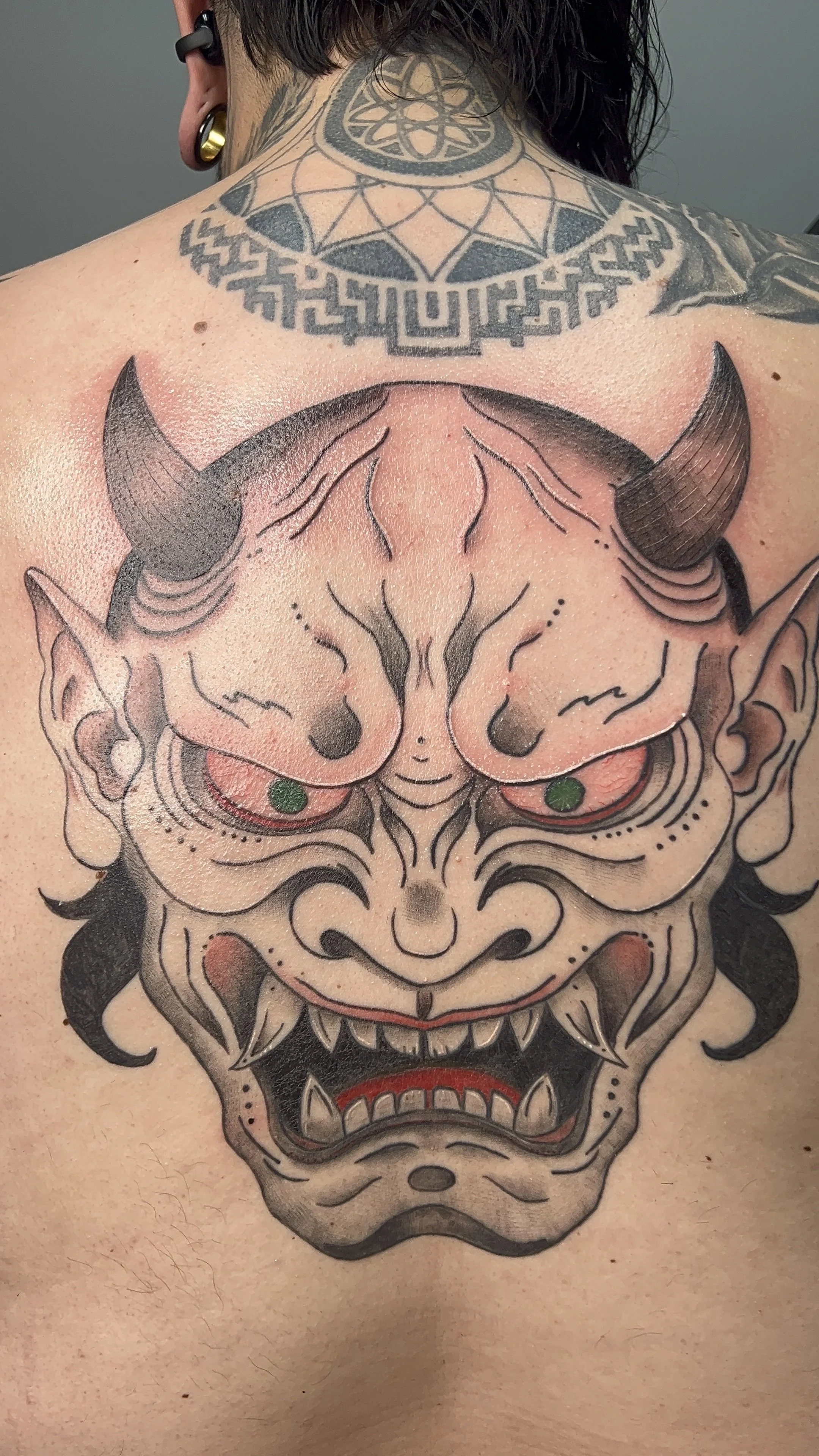 Custom color Hannya mask tattoo inspired by traditional Japanese tattoo art.