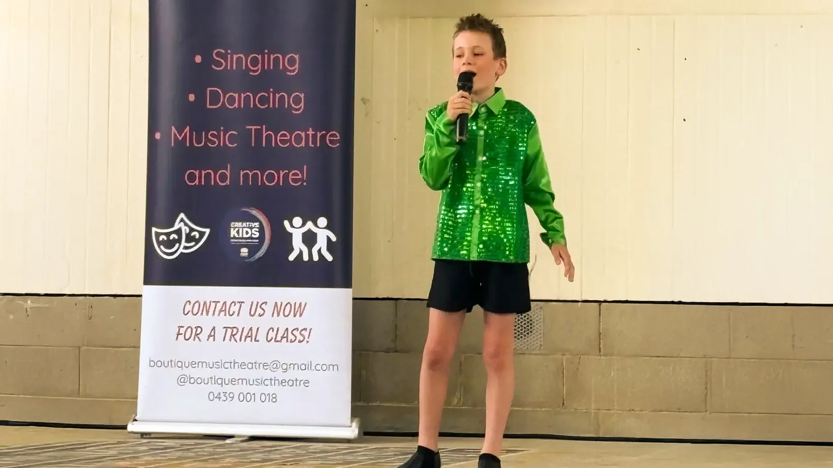A child performing in a confidence-building musical theatre performance