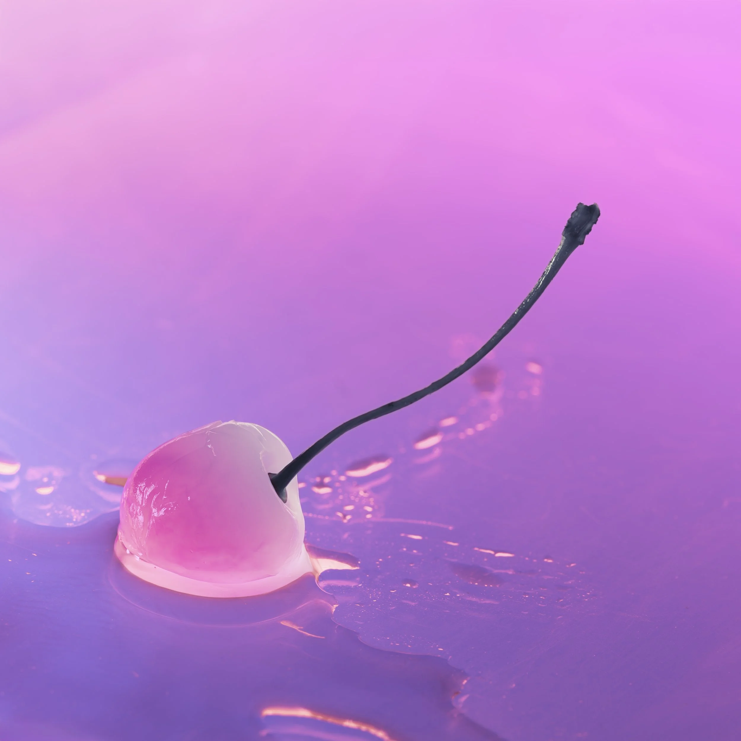 Close-up of a small pink ice cream cone with a scoop of pink ice cream, and a lit sparkler stick in the background, set against a purple-pink gradient background.