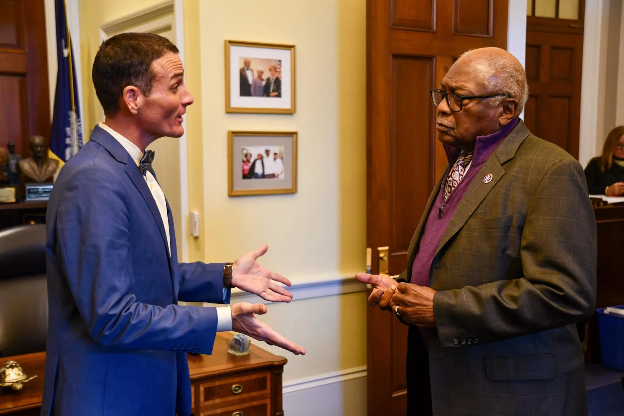 Two men having a serious conversation in an office setting.