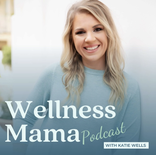 A smiling woman with blonde hair in a light blue top promoting the Wellness Mama podcast with Katie Wells.