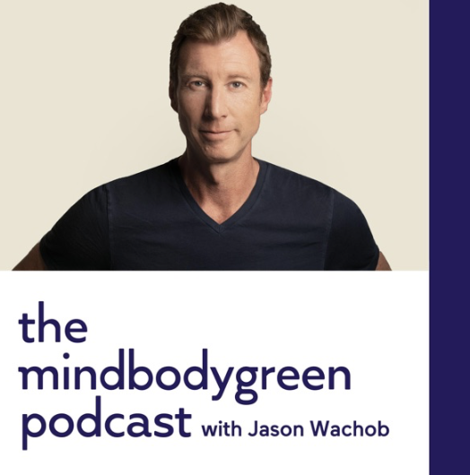 Cover image for 'The Mindbodygreen Podcast' featuring Jason Wachob, a man with short brown hair wearing a dark V-neck shirt, against a split beige and dark blue background.