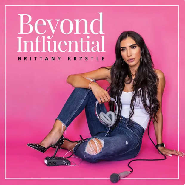 Cover of a magazine or book titled 'Beyond Influential' featuring Brittany Krystle sitting on the floor against a pink background, wearing ripped jeans, a white top, and black heels, with headphones and a microphone.