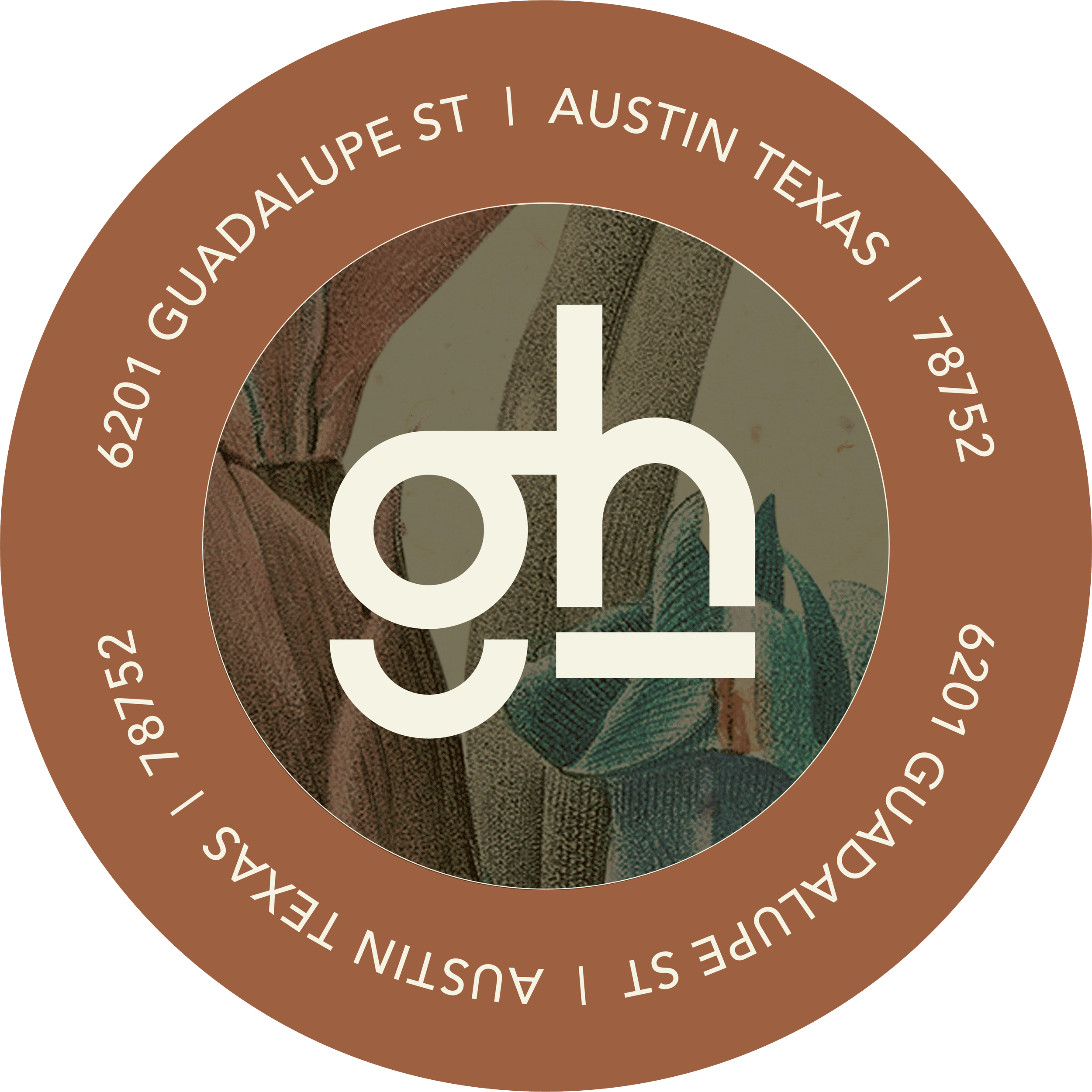 Close-up of a circular graphic with a brown border, featuring the text '6201 GUADALUPE ST | AUSTIN TEXAS | 78752' and the date '2018.52'. The inner circle contains a logo with lowercase 'g' and 'h' intertwined, overlaid on a background that appears to be a painted or illustrated image of leaves and wooden textures.
