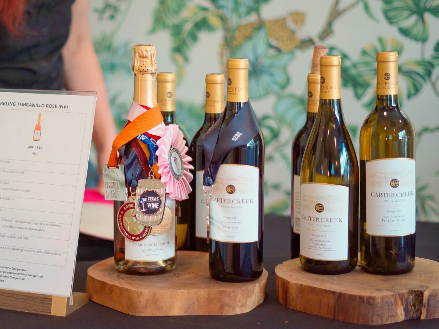  Texas Hill Country wines displayed during a community-focused wine tasting event at Guad Haus. 