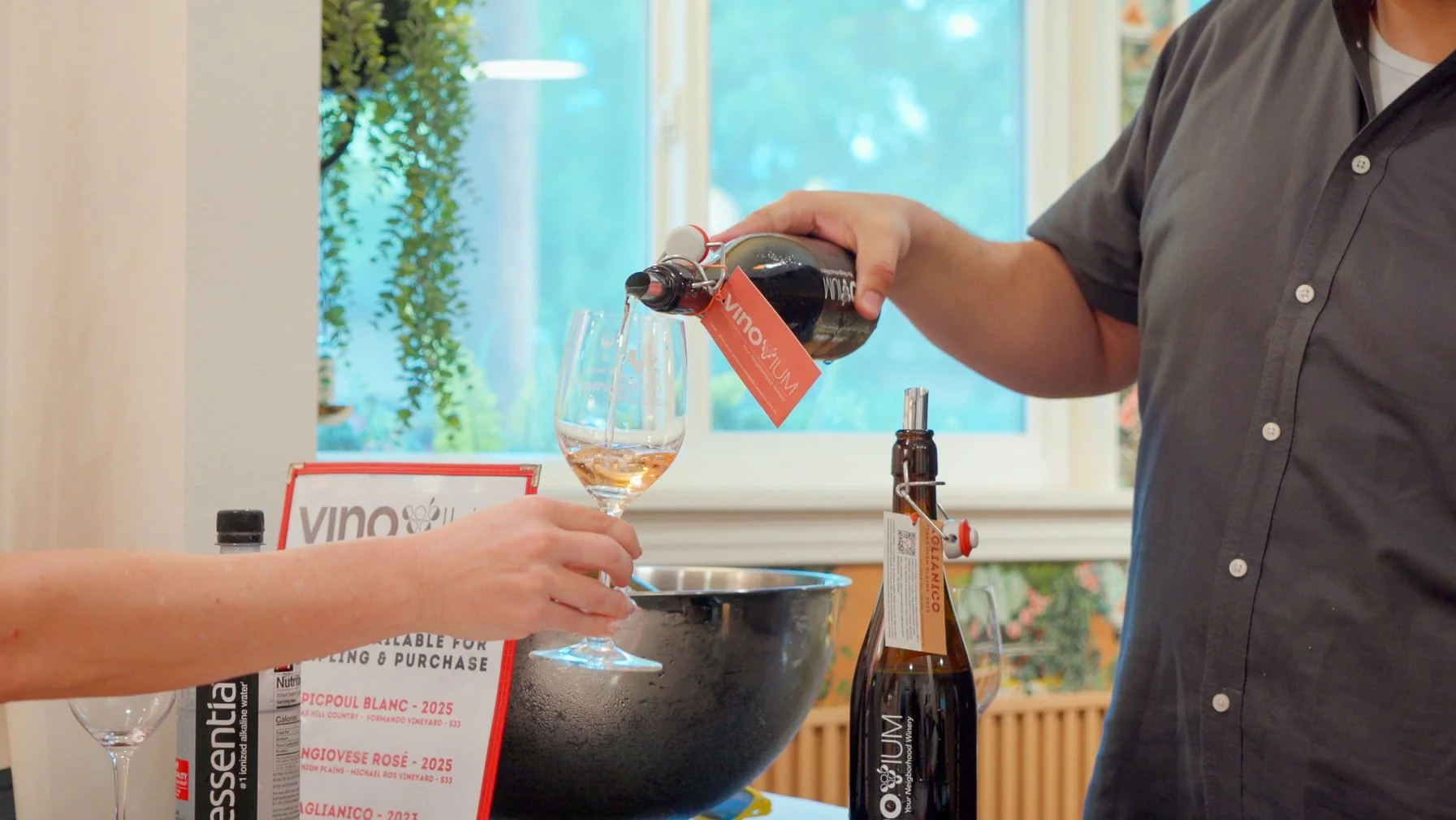  Winery representative pouring wine for guests during a tasting event at Guad Haus in Austin. 