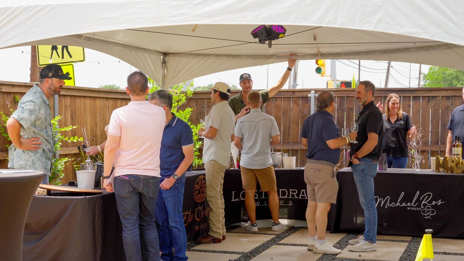 Attendees sampling wines and connecting with winery representatives during the Texas Wine Experience at Guad Haus in Austin, Texas.