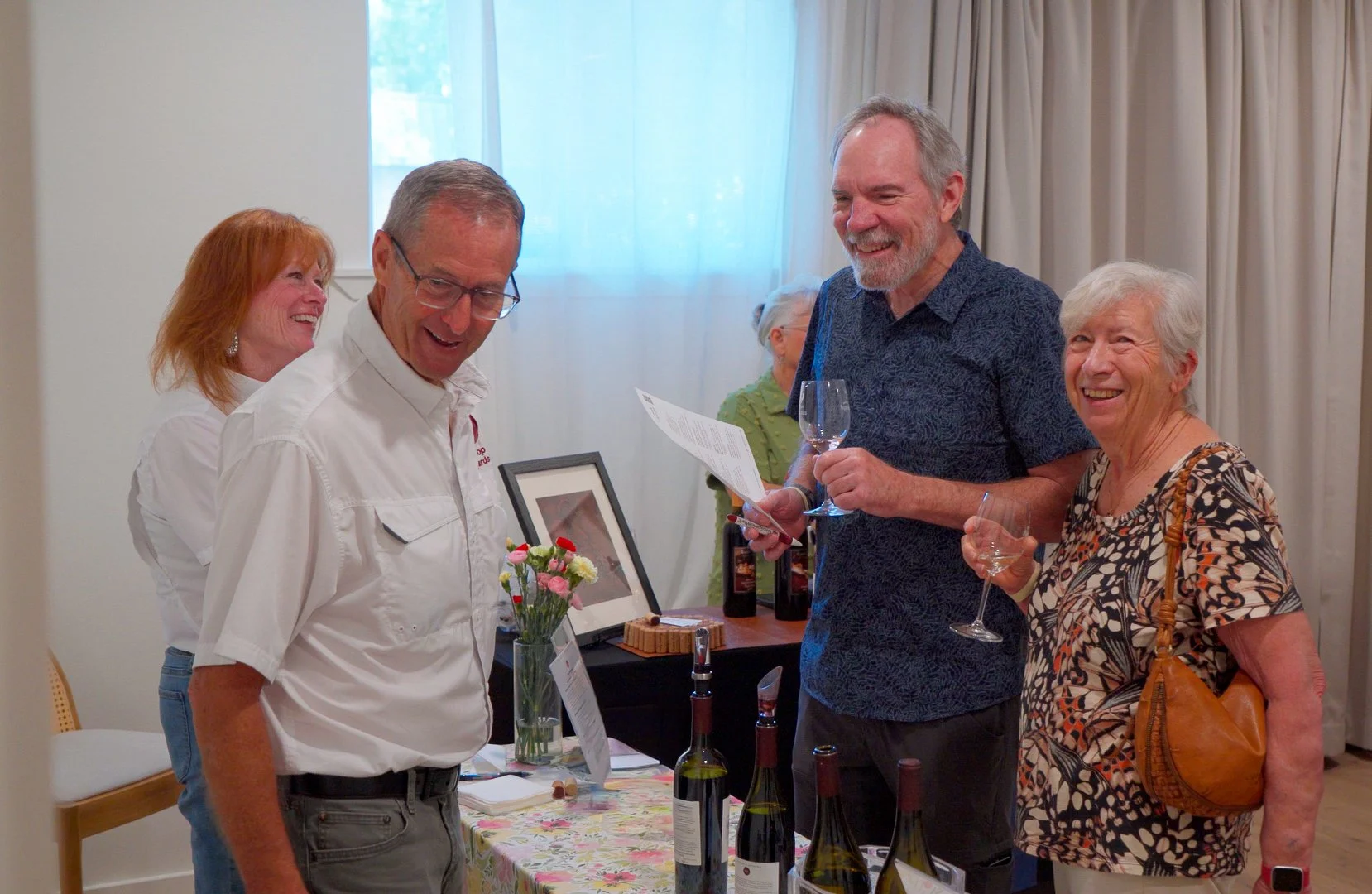 Attendees networking and learning from Texas wine producers at Guad Haus, an Austin event venue designed for community gatherings.