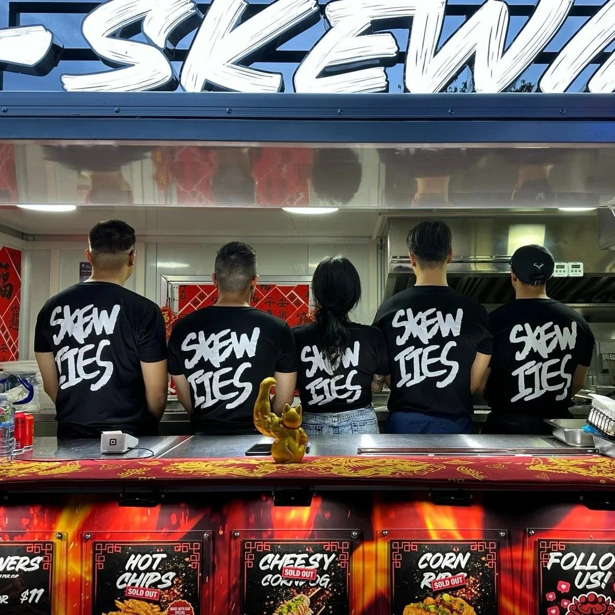 Skewiies team members and staff taking group photo after selling out at an event.