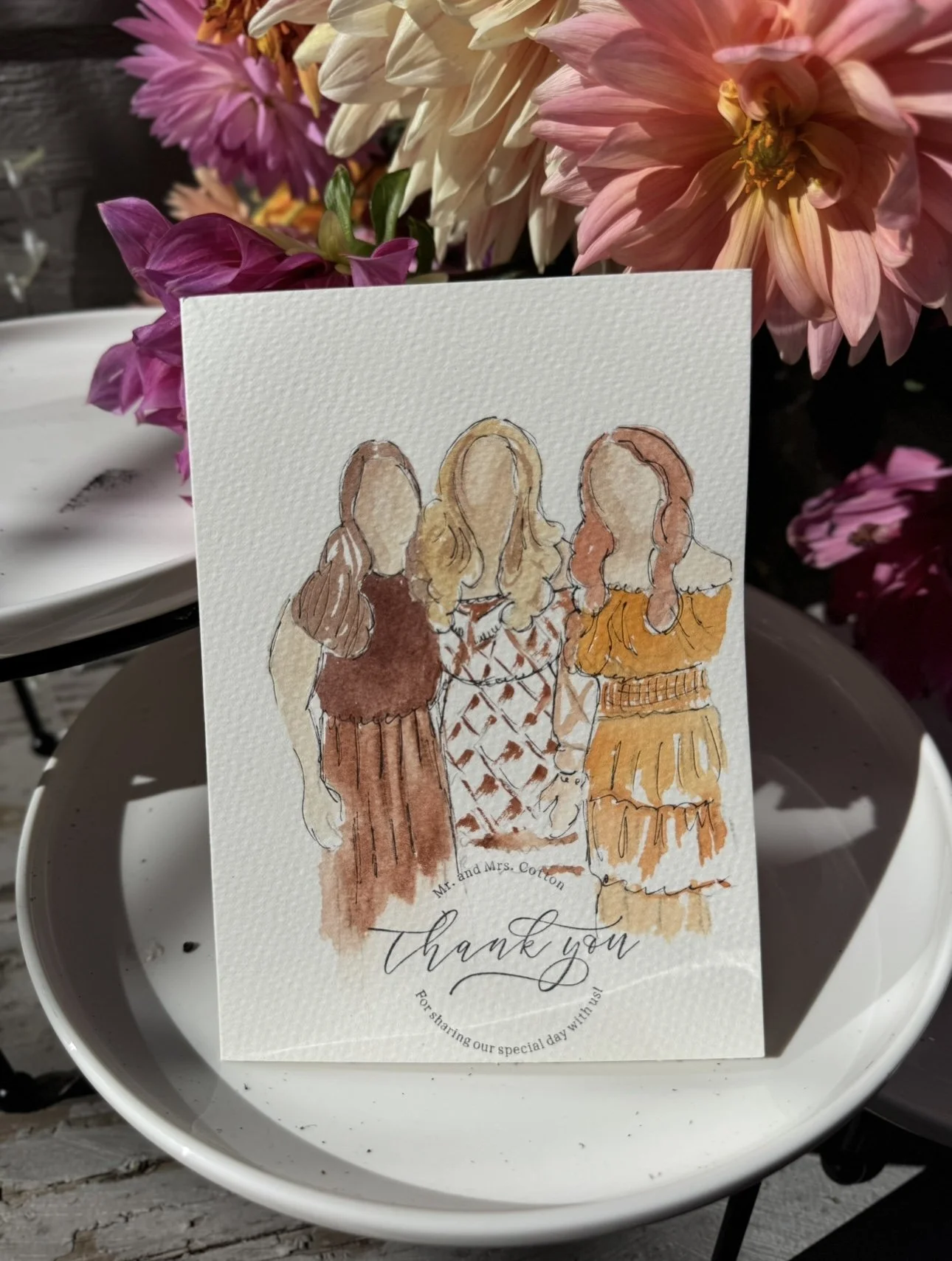 A thank you card with an illustration of three women from behind, surrounded by pink and beige flowers.