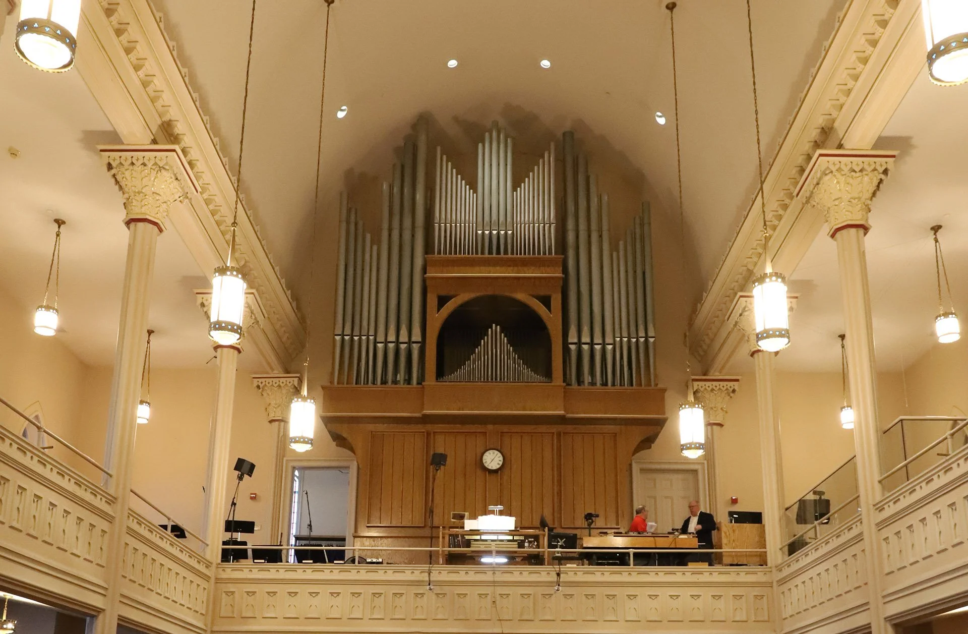 Interior view Immanuel Lutheran Church with ornate architectural details, displaying a large pipe organ at the front and a balcony on the sides.