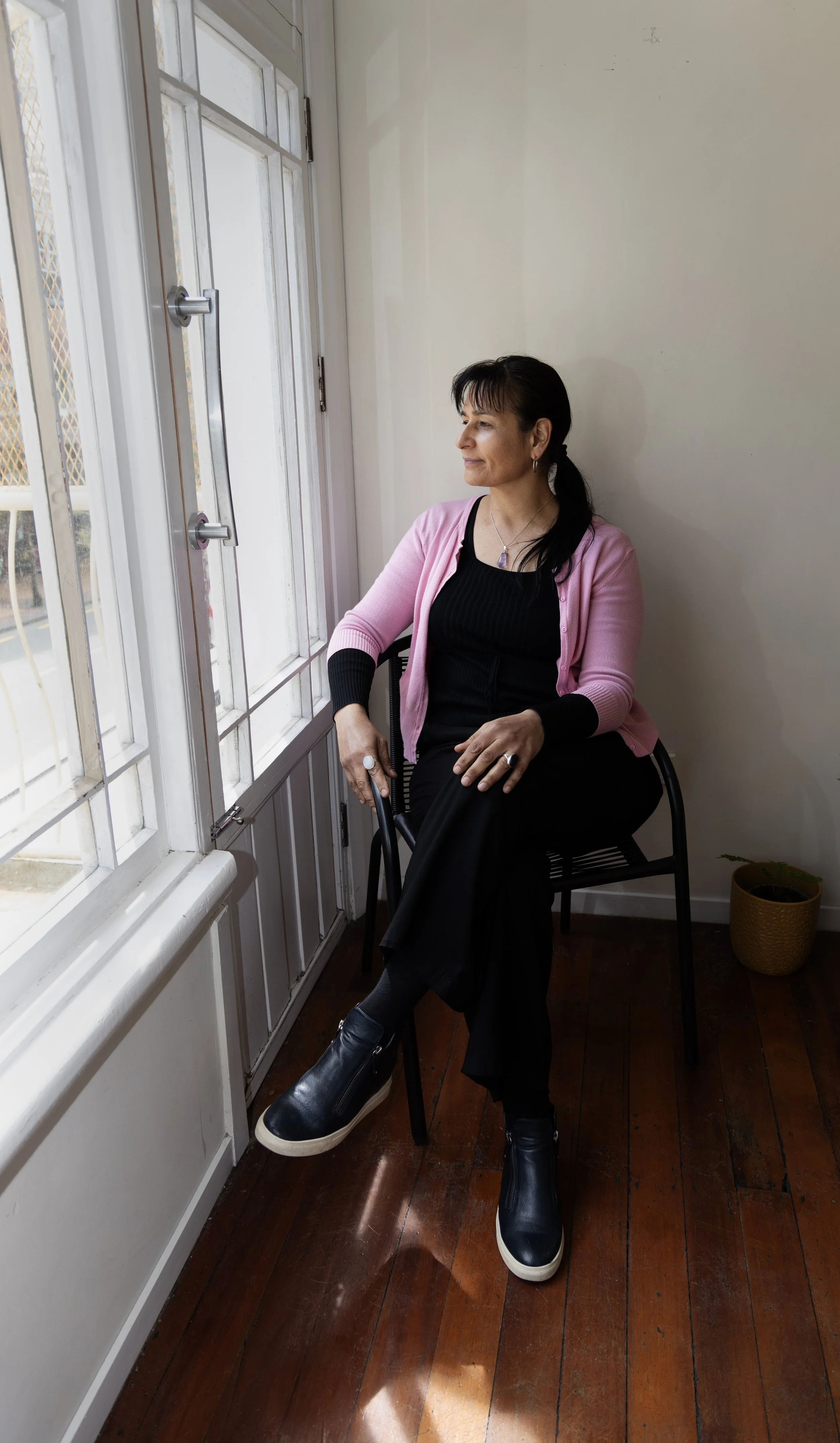 Sonia.B Clairvoyant seated looking over balcony.