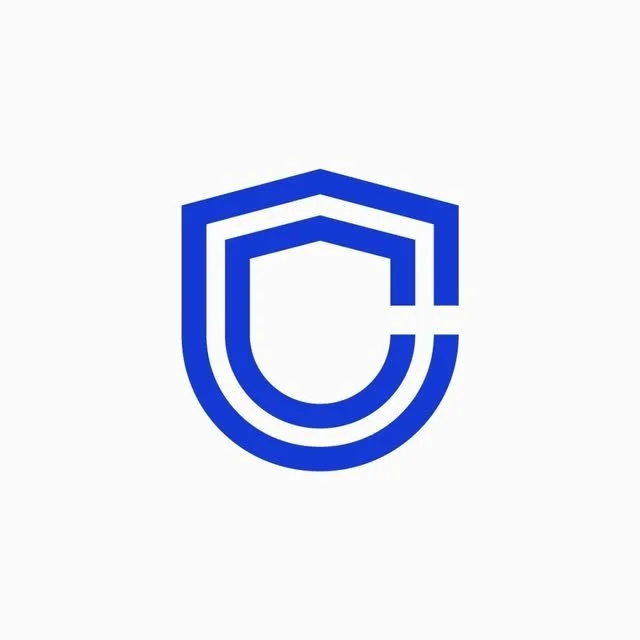 A brand logo for the creator marketplace Creator Brand Hub, consisting of two blue outlines that form the shape of a shield.