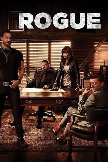 Four people in a dimly lit wooden-paneled office with the word "ROGUE" above them. One man standing to the left, another seated at a desk, a woman standing behind him, and a man seated in a chair to the right.