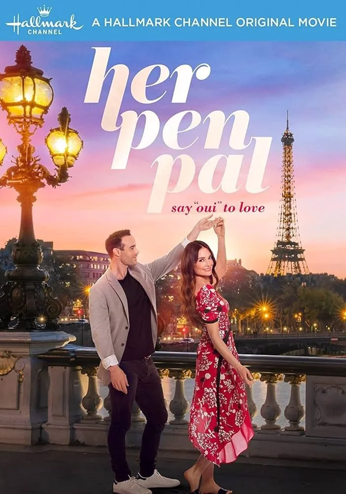 Cover for the Hallmark Channel movie "Her Pen Pal" featuring a man and a woman dancing on a bridge with the Eiffel Tower in the background at sunset, with street lamps lighting up the scene.