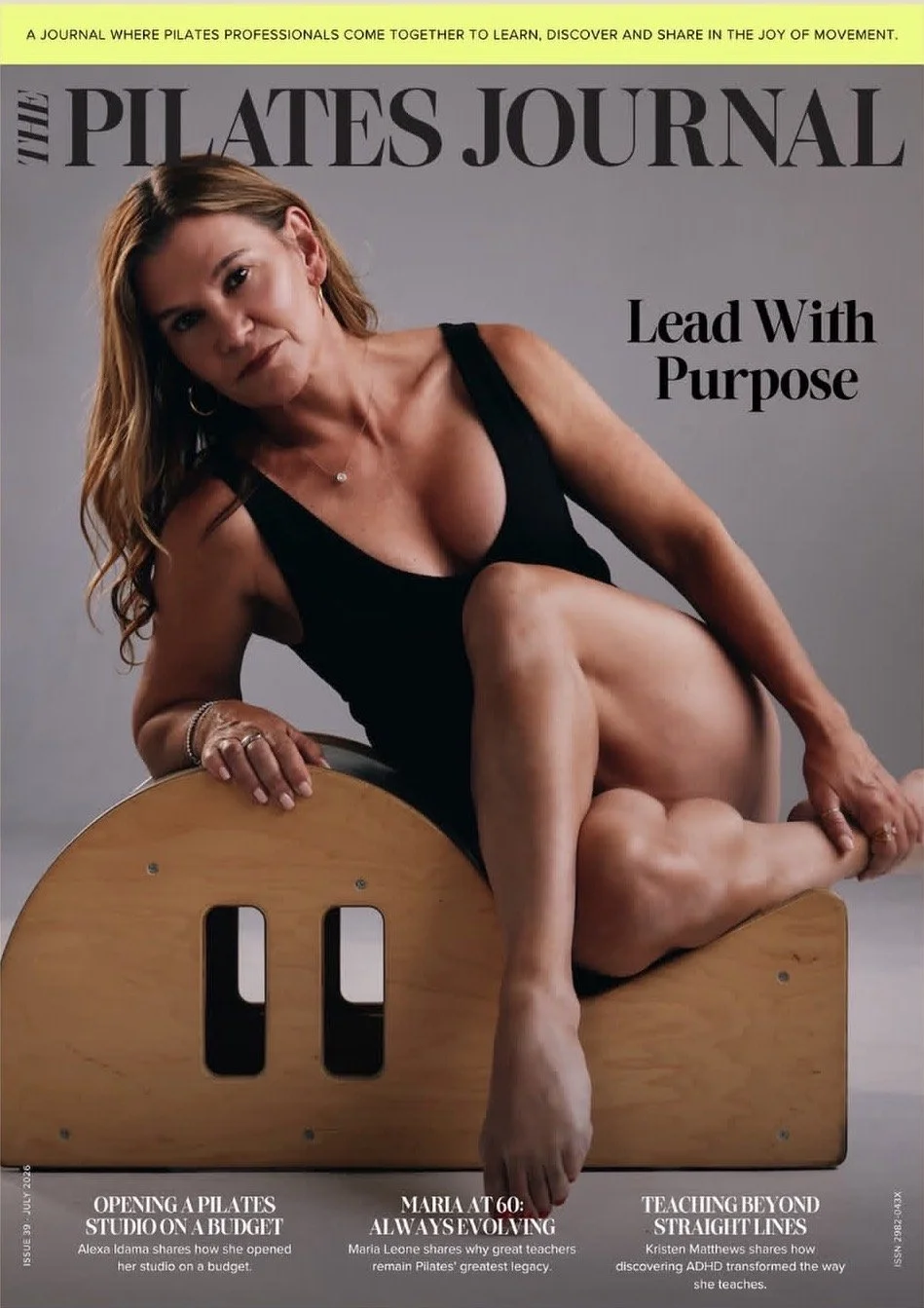 Cover of The Pilates Journal magazine featuring a woman in a black tank top, sitting on a Pilates reformer, with the headline "Lead With Purpose".