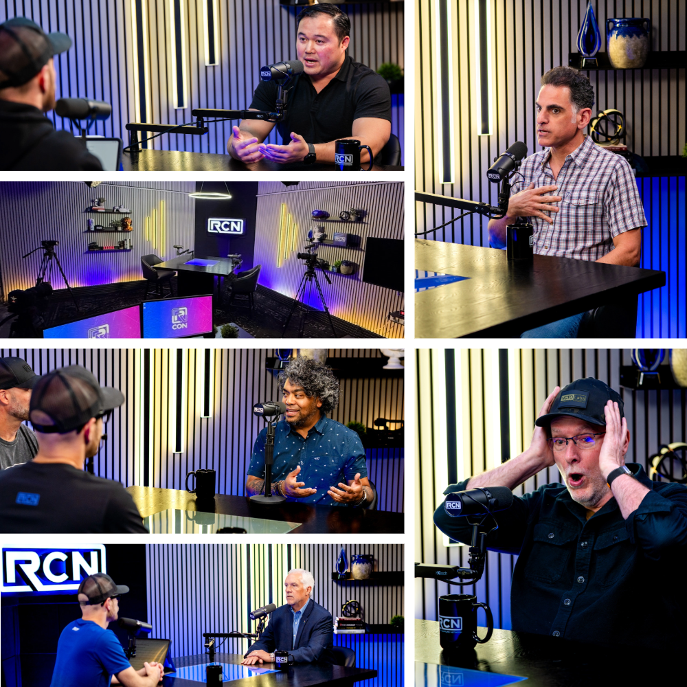 A podcast recording studio with four guests and a host sitting at a table with microphones. The studio has modern decor with lighting and shelves, and two cameras are set up to record the discussion.